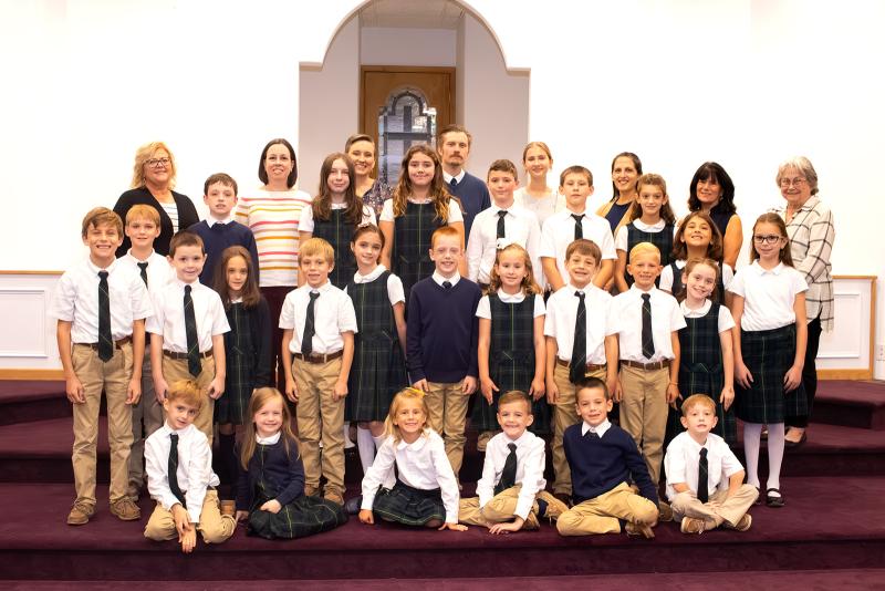 Legacy Academy educators and students in kindergarten through eighth grade gather for a group photograph. SUBMITTED PHOTO